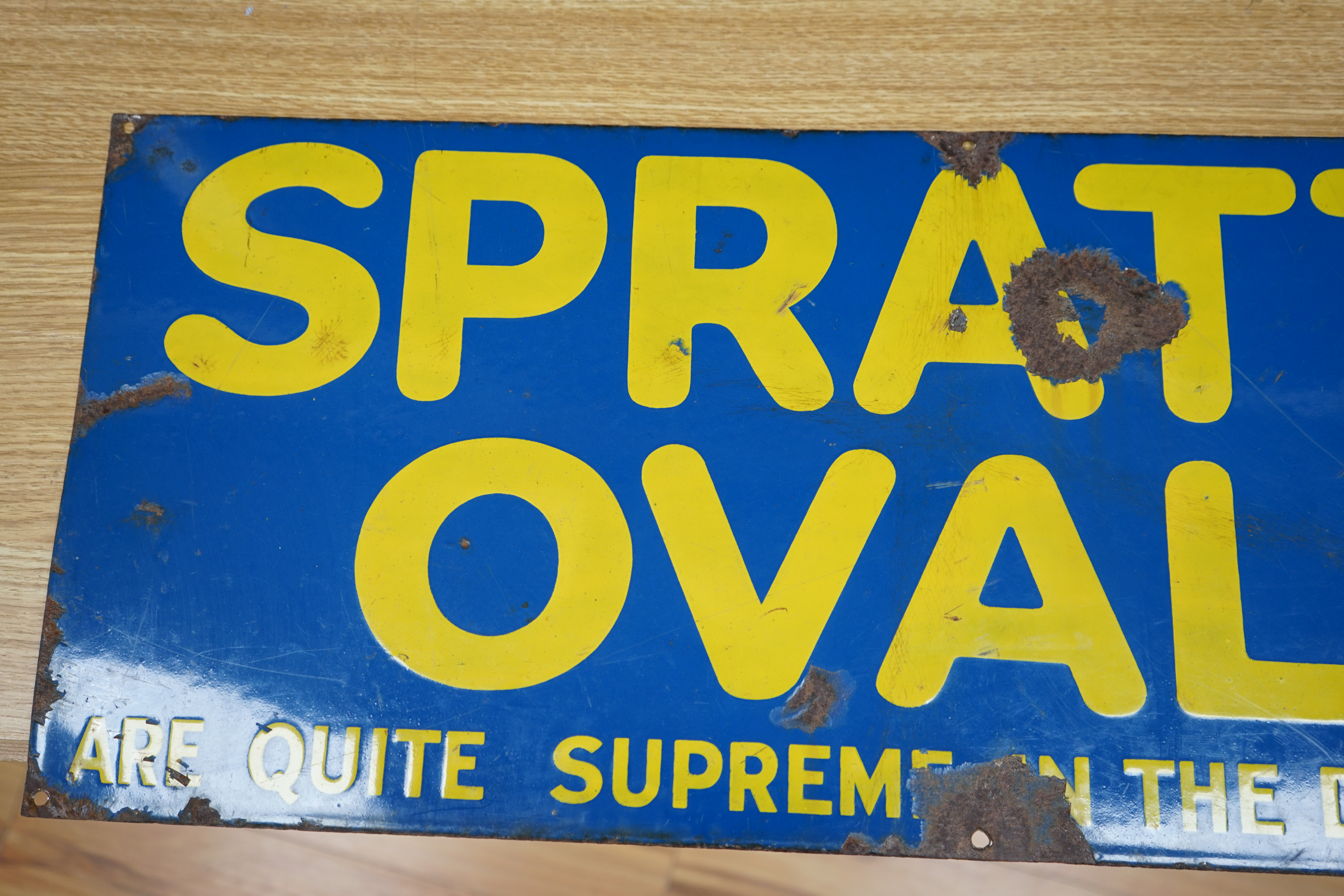 An advertising enamel sign, Spratts Ovals are quite the Supreme in the Dog's Esteem, Wood & Penfold Ltd., 30.5 x 76cm. Condition - poor to fair, several losses as photographed